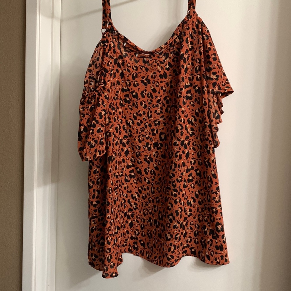 Torrid blouse with a slight open shoulder and crisscross design in the front